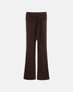 Detail of dark brown wide leg pants featuring a stylish waist tie and smooth fabric texture