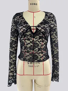Detail of V-neck lace top with intricate floral hollow pattern and delicate tie-front design