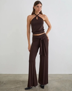 Detail of dark brown two-piece set featuring halter neck top and high-waist wide-leg pants