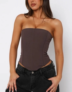 Detail of dark brown corset top showing supportive boning and pointed asymmetrical hemline