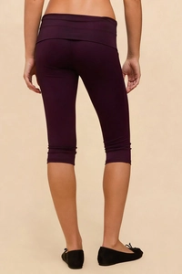 Close-up of deep purple high-waisted capri leggings with a fold-over waistband design