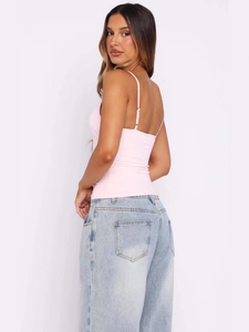 Women's light pink V-neck sleeveless cropped top with pleated texture and blue wide-leg jeans