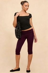 Close-up of women's purple cropped leggings with a trendy fold-over waistband design