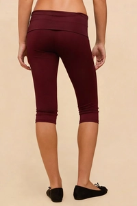 Close-up back view of burgundy cropped yoga leggings with a crossover high waist design