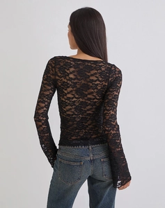 Detail shot of the sheer floral lace back and flared sleeves of a black slim-fit top