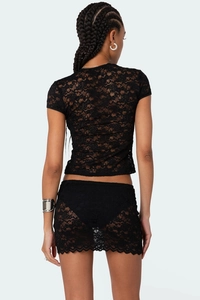 Rear view of black lace two-piece set featuring floral mesh top and matching mini skirt