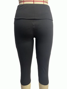Back view of high waist black yoga pants with push-up effect on white mannequin