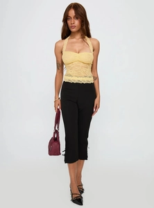 Detail showing the sheer lace crochet texture and ruffled hem of a halter neck top