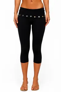 Close-up of black high-waisted capri yoga pants featuring decorative waist buttons