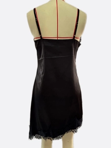 Detail of the black satin slip dress with delicate lace trim and adjustable thin straps