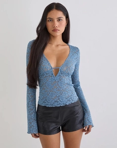 Detail of blue lace V-neck top showing hollow floral texture and scalloped flared sleeves