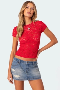 Close-up of red floral lace fabric and sheer texture of women's slim-fit summer top