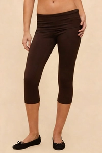 Detail view of high-waist slimming capri leggings in deep brown with wide waistband