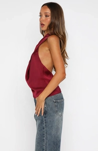 Detail of burgundy satin halter top with elegant cowl neck and backless silhouette