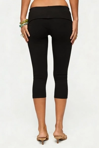 Detail of high waisted black cropped leggings featuring butt lifting fit and soft texture
