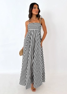 Detail of striped maxi dress featuring thin straps and pleated flare skirt design