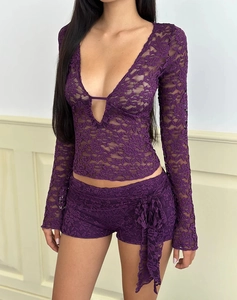 Detail of purple lace two-piece set featuring V-neck long sleeves and matching shorts