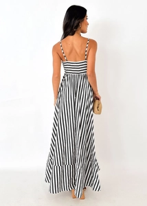 Detail of elegant black and white striped maxi dress with ruffle hem and back design