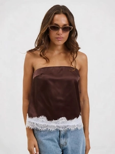 Brown satin tube top with white eyelash lace hem paired with denim jeans