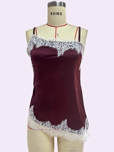Detailed view of wine red satin camisole with white eyelash lace trim on a mannequin