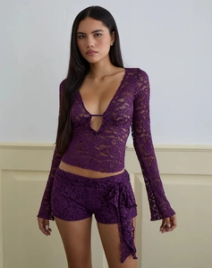 Close-up of deep purple floral lace long sleeve top with delicate scalloped V-neck detail