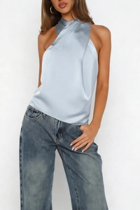 Detail of cross halter neck design on light blue satin sleeveless top for women