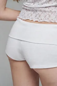 Detailed view of white ribbed high-waisted shorts featuring a comfortable fold-over waistband
