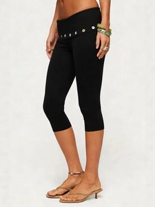 Women's black high waist capri leggings with decorative button detail for yoga and fitness