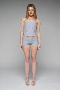 Detail of light grey two-piece lounge set with tube top, bow accent, and slim shorts
