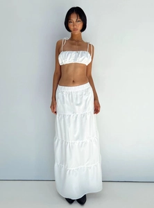 Detailed texture of white two-piece set featuring ruffled crop top and tiered maxi skirt