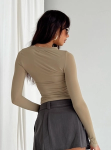 Detail view of khaki slim fit long sleeve top with premium knitted texture and tight fit
