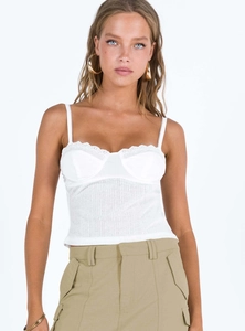 Detailed view of white camisole with lace trim, padded bust cups, and ribbed texture