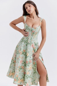 Detail view of floral midi dress with corset waist and side slit in mint green fabric