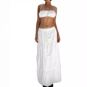White two-piece summer set with spaghetti strap crop top and tiered maxi skirt