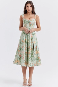 Close-up of a floral midi dress featuring a corset waist and a high side slit detail