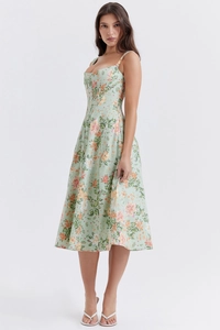 Detail view of floral midi dress featuring slim straps and a mint green summer pattern