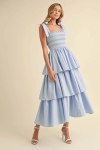Detail of light blue tiered sun dress with smocked bodice and adjustable bow straps