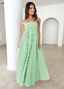 Detail of green and white striped maxi dress showing vertical and diagonal fabric patterns
