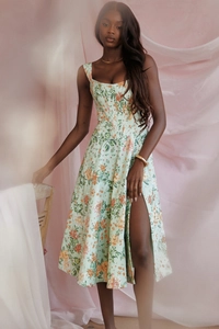 Detail of mint green floral dress featuring a corset bodice and high side slit