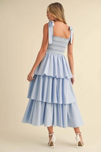 Detail of light blue tiered dress featuring smocked back and bow-knot shoulder straps