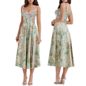 Detail of light green floral midi dress featuring a lace-up corset and side slit