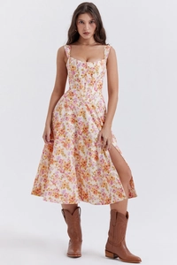 Detail of floral summer dress featuring square neck, corset waist, and high side slit