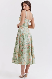 Detail view of tropical floral midi dress with back slit and slim fit waist design