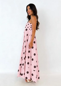 Detail view of pink maxi dress with black polka dots and elegant sleeveless spaghetti straps