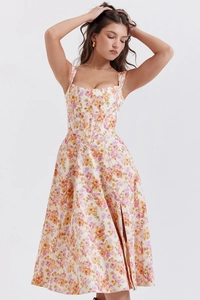 Close-up of summer floral midi dress featuring a corset bodice and side slit detail