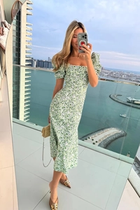 Detail of square neckline and puff sleeves on a green floral midi dress for summer