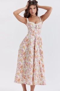 Detail of bustier bodice with bow tie and vintage floral pattern on midi sun dress