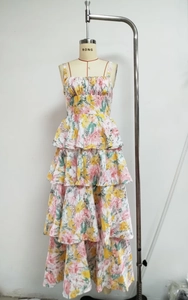 Detailed view of layered floral chiffon dress with pink and yellow botanical patterns