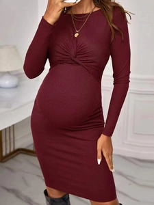 Detail of burgundy maternity dress showing ribbed knit texture and front twist knot