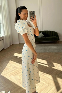 Detail of puff sleeves and square neckline on a white floral print midi dress for women